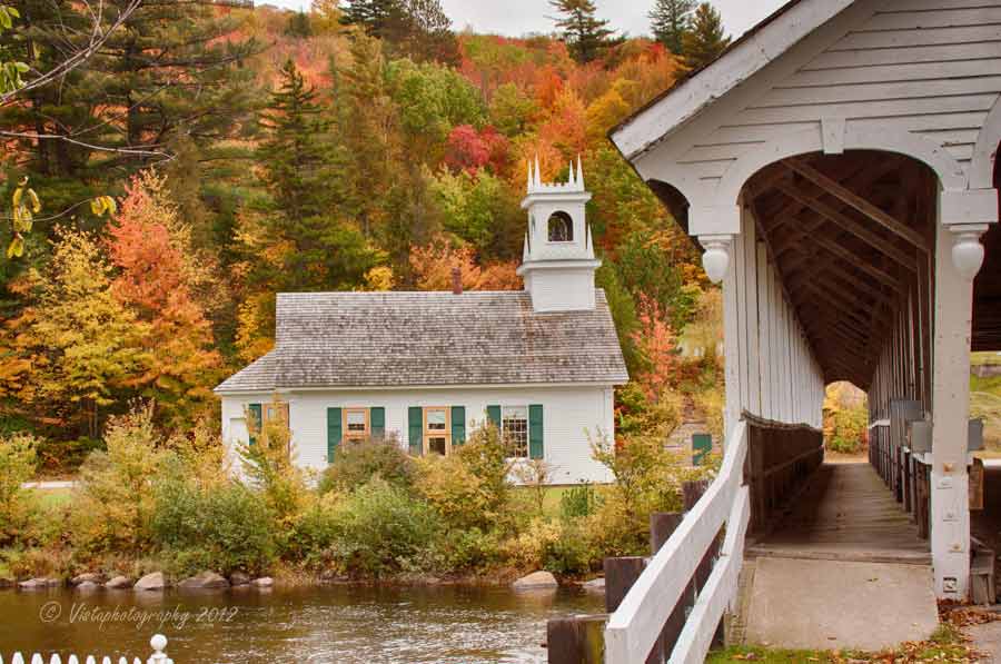 Stark covered bridge and church in autumn