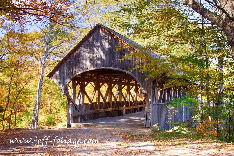 The end view of the Sunday River Covered Bridge with Maine fall foliage