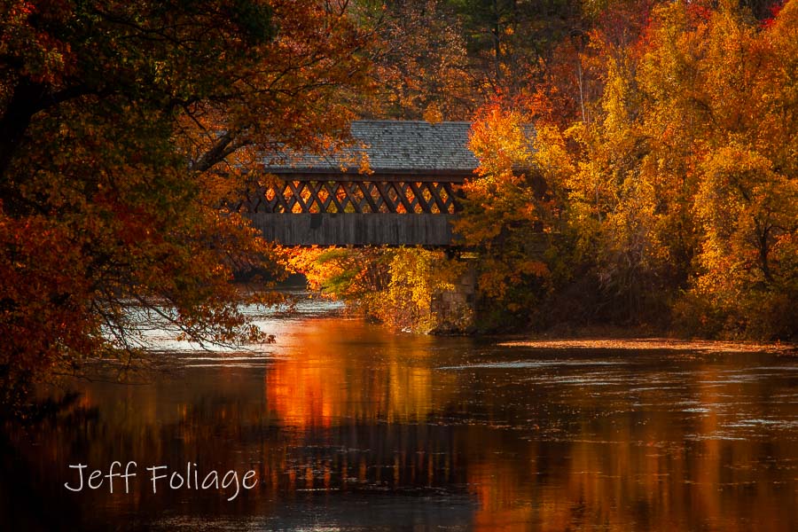 The fall colors surround the Henniker covered bridge in New Hampshire. 
