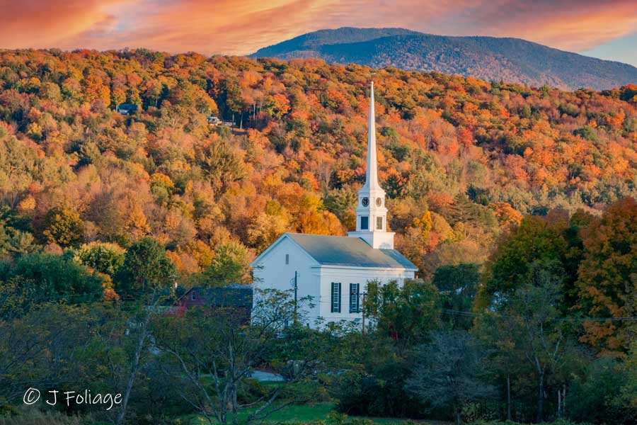 Stowe Vermont church in autumn fall colors at sunset