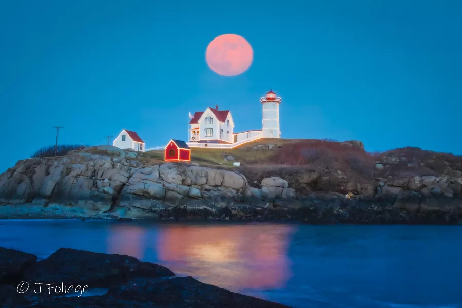 nubble lighthouse with a full moon 