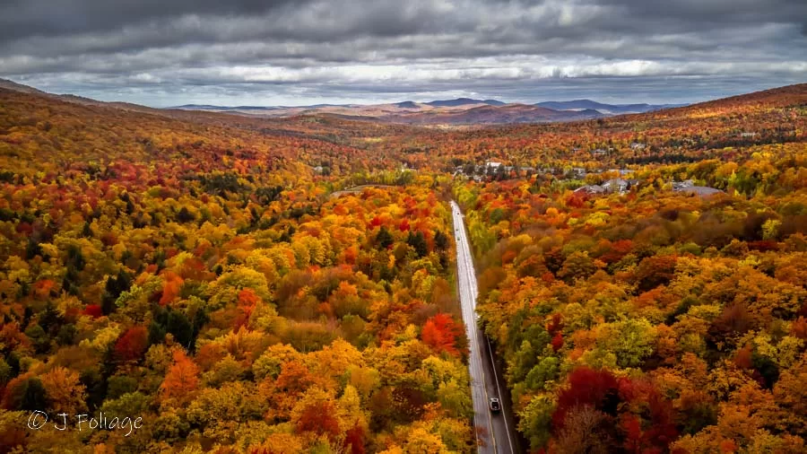 Drone view of Looking towards Jeffersonville from Smuggler's Notch Vermont in blazing fall colors