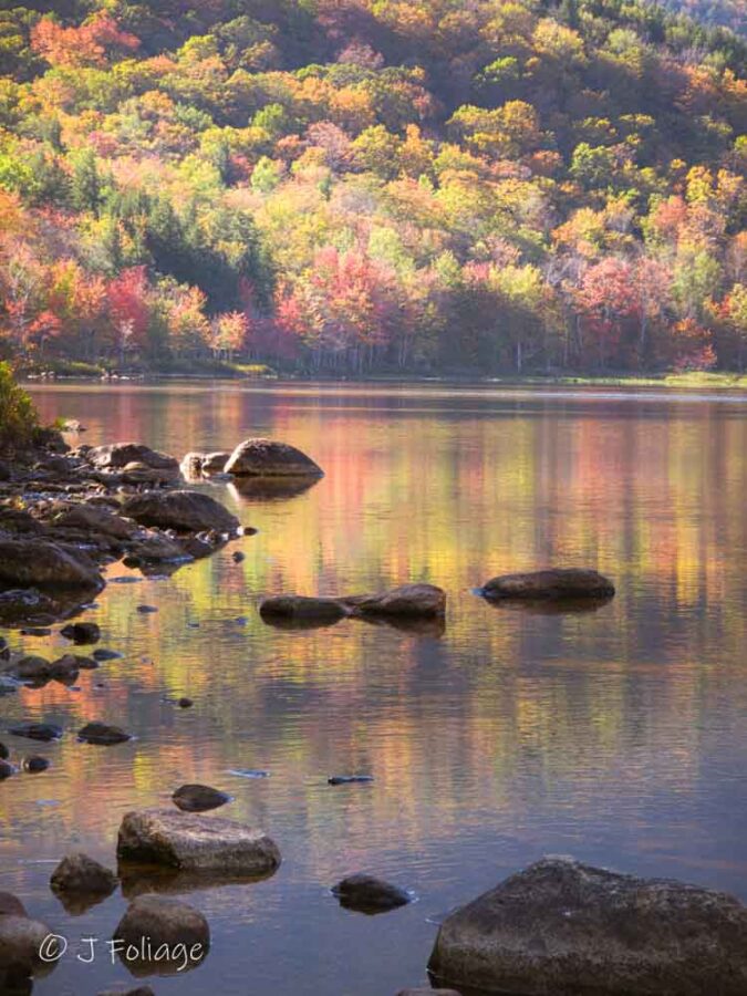 The fall color glowing at the Basin in Evan's Notch
