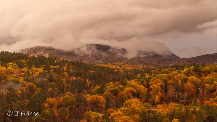 Mount Moosilauke shrouded by low hanging clouds in late autumn fall colors