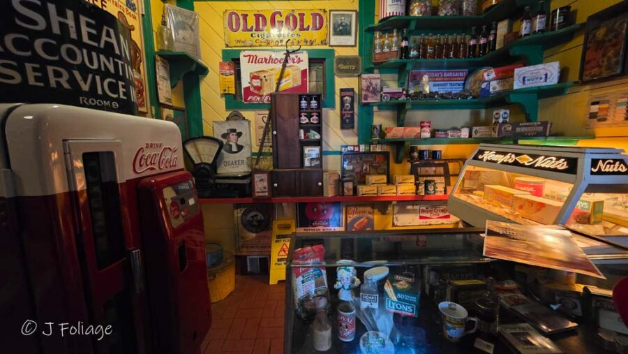 Interior Memorabilia 1: Walls of May Kelly's restaurant densely covered in vintage Irish signs, antique memorabilia, and old advertisements.