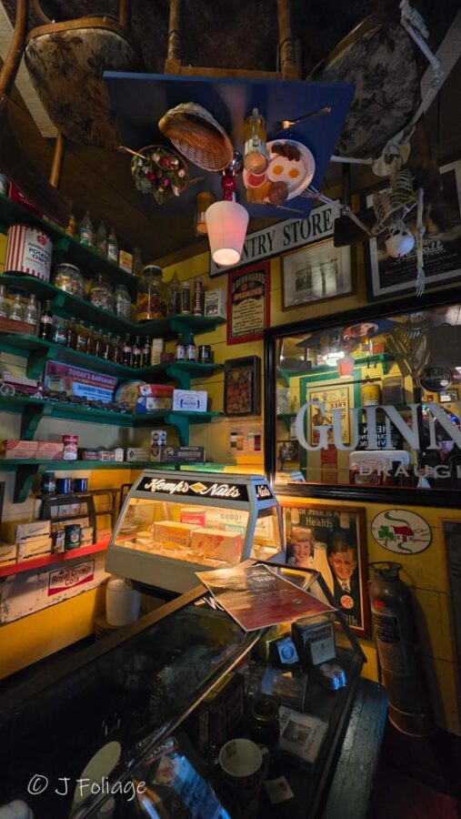 Interior Memorabilia 1: Walls of May Kelly's restaurant densely covered in vintage Irish signs, antique memorabilia, and old advertisements.