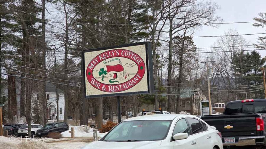 Exterior: The bright yellow exterior of May Kelly’s Cottage Bar and Restaurant in North Conway, surrounded by winter snow.